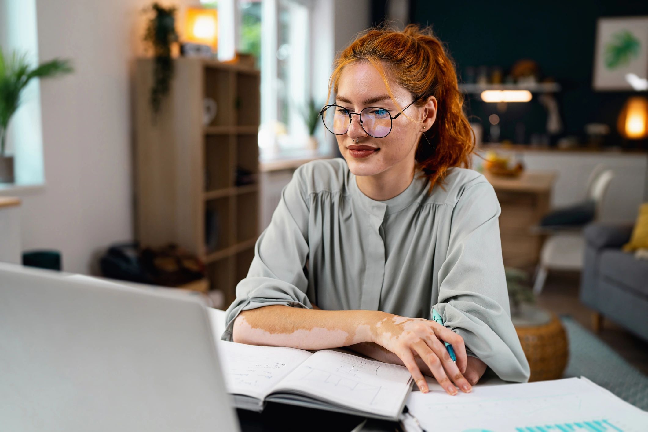Person working on a laptop during a remote coaching session